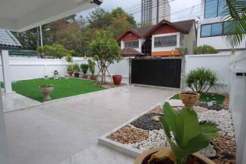 Spacious backyard with garden and paved area