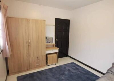 Bedroom with wardrobe, desk with chair, and dark door