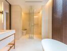 Modern bathroom with glass shower partition and bathtub