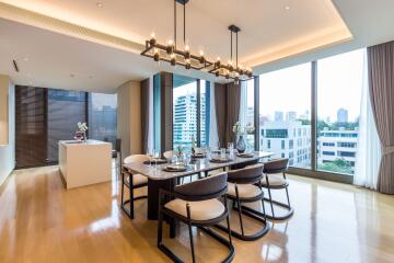 Spacious dining area with large windows and elegant furniture