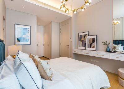 Elegant bedroom with modern decor featuring a plush bed, stylish wall art, and contemporary lighting fixtures