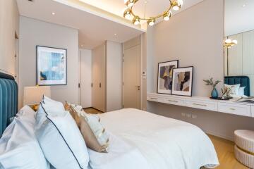 Elegant bedroom with modern decor featuring a plush bed, stylish wall art, and contemporary lighting fixtures