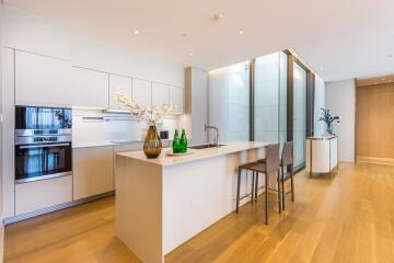 Modern kitchen with island, bar stools, and built-in appliances