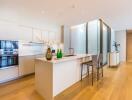 Modern kitchen with island, bar stools, and built-in appliances