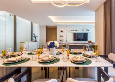 Modern dining room with a set table and view into the living area