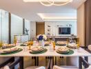 Modern dining room with a set table and view into the living area