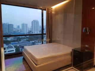 Bedroom with a large window and city view