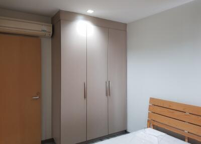 bedroom with wardrobe and air conditioning unit