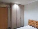 bedroom with wardrobe and air conditioning unit