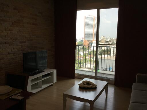 Cozy living room with TV and a city view