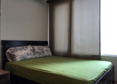 Cozy bedroom with a green bed sheet and large window