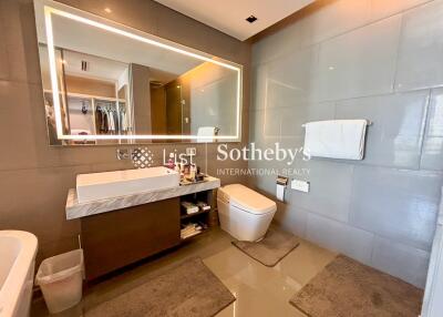 Modern bathroom with large mirror and grey tiles