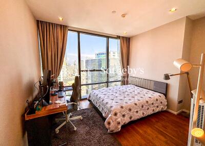 Modern bedroom with a large window offering city views