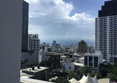 Cityscape view from a high vantage point, featuring skyscrapers and cloudy sky