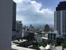 Cityscape view from a high vantage point, featuring skyscrapers and cloudy sky