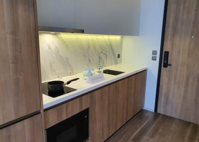 Modern kitchen with wooden cabinets and marble backsplash