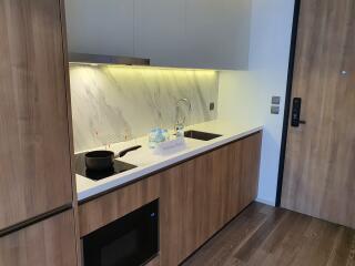 Modern kitchen with wooden cabinets and marble backsplash