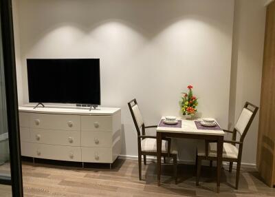 A tastefully decorated living area with a TV and dining table