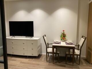 A tastefully decorated living area with a TV and dining table