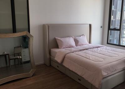 Modern bedroom with large mirror and natural light