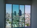 Bedroom with a large window providing a cityscape view