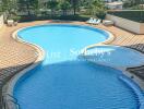 View of outdoor swimming pool with surrounding cityscape