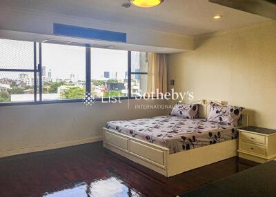 Bedroom with large window and bed