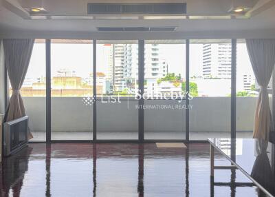 Bright living room with large windows offering city view.