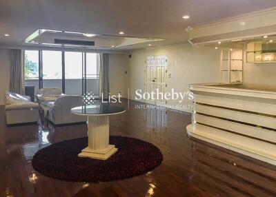 Spacious living room with modern decor and a bar area