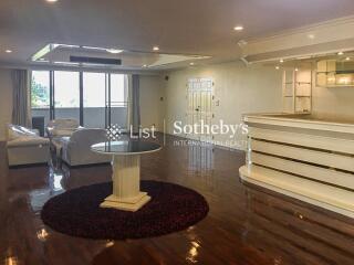 Spacious living room with modern decor and a bar area