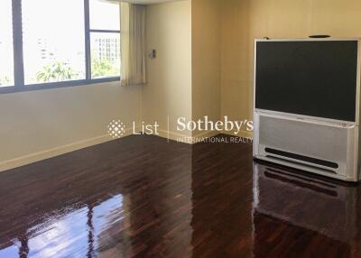 Spacious living room with a large window and a TV stand