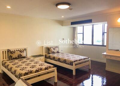 Bedroom with two single beds and a large window