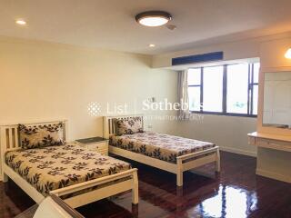 Bedroom with two single beds and a large window