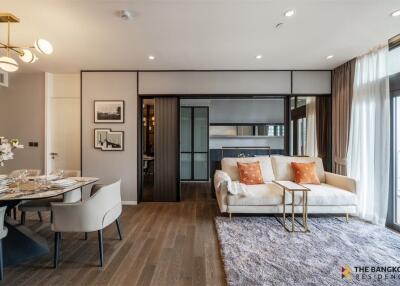 Modern living room with dining area, cozy sofa and natural light