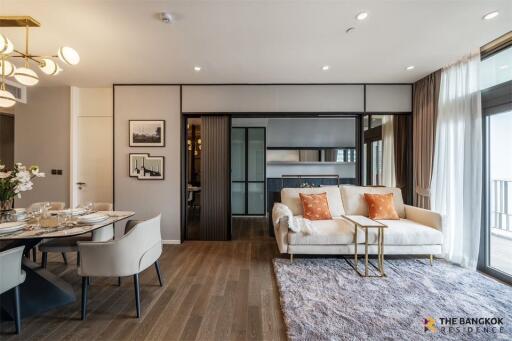 Modern living room with dining area, cozy sofa and natural light