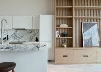 Modern kitchen with marble countertops and wooden shelving