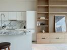 Modern kitchen with marble countertops and wooden shelving