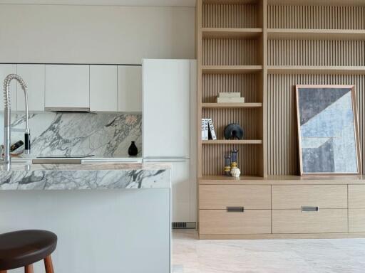 Modern kitchen with marble countertops and wooden shelving