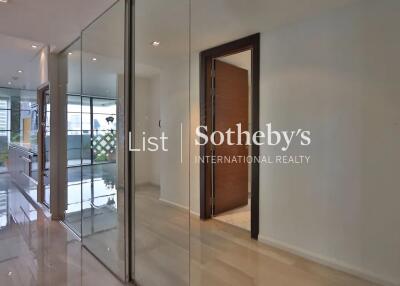 Modern hallway with glass walls and wooden door