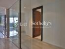 Modern hallway with glass walls and wooden door