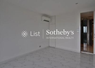 Empty bedroom with white walls and marble flooring