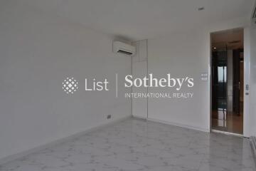 Empty bedroom with white walls and marble flooring