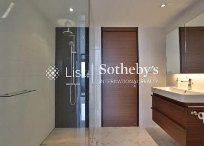 Modern bathroom with glass-enclosed shower and wooden vanity