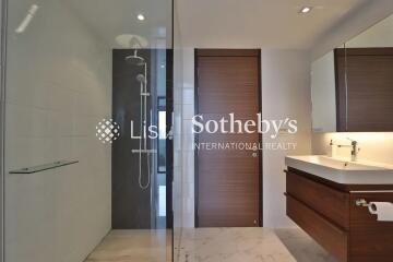 Modern bathroom with glass-enclosed shower and wooden vanity