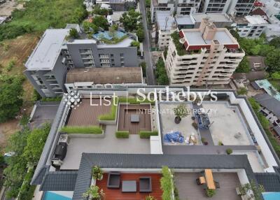 Aerial view of a rooftop with various outdoor spaces in an urban area.