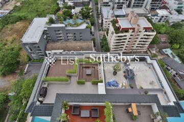 Aerial view of a rooftop with various outdoor spaces in an urban area.