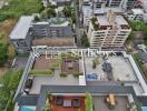 Aerial view of a rooftop with various outdoor spaces in an urban area.