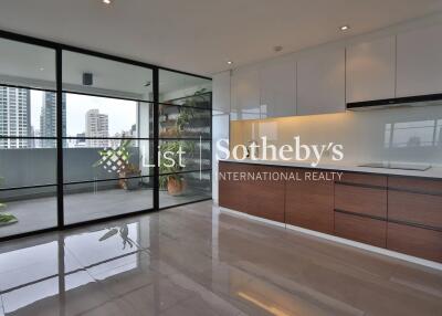 Modern kitchen with large sliding glass doors and city view