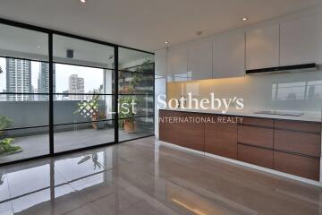 Modern kitchen with large sliding glass doors and city view