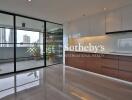 Modern kitchen with large sliding glass doors and city view